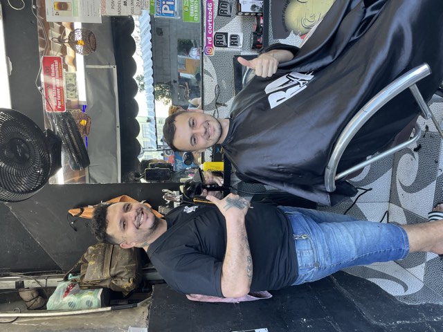 A barber shop in Brazil with a man getting a haircut A barber shop in Brazil with a man getting a haircut